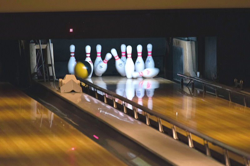 Bowling ball rolling down lane with bumpers